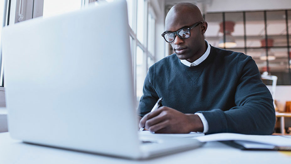 man looking at his laptop